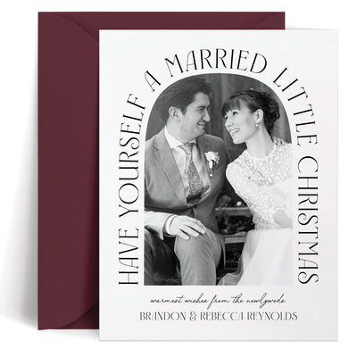 Custom greeting card with a wedding photo and text 'Have Yourself a Married Little Christmas' on a white background.