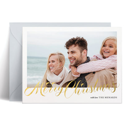 Custom Christmas card with family photo and 'Merry Christmas' in gold calligraphy on a white background