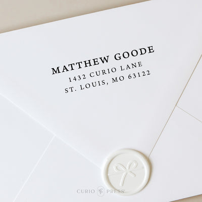 Elegant address stamp with full serif font for name and address, stamped in black ink on envelope for a traditional look