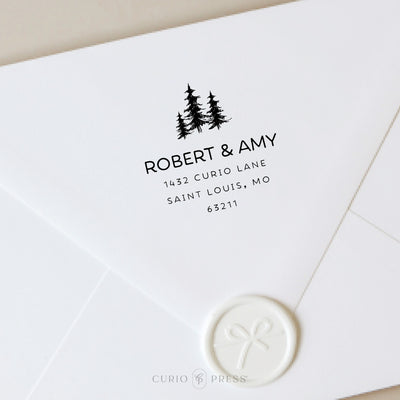 Custom address stamp with three hand-drawn trees and rounded modern text, stamped in black ink on envelope