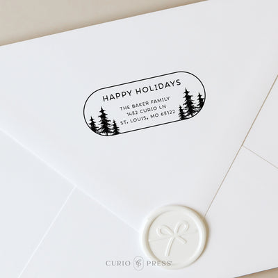 Custom holiday stamp with a Christmas tree forest design on a white envelope with wax seal